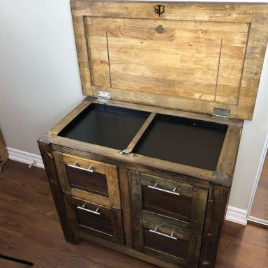 Wooden storage cabinet with dual compartments and four lower drawers.